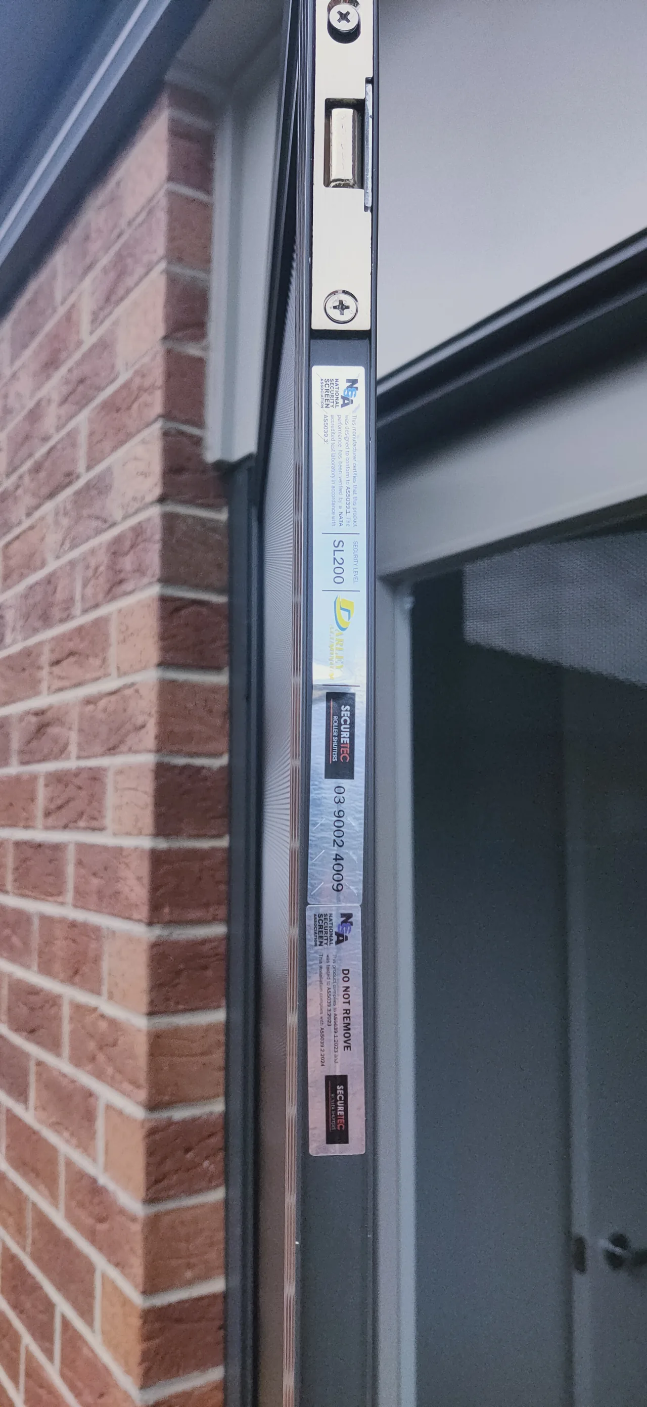 Compliance label on an installed security door showing NSSA membership and Security Level SL200 to AS5039